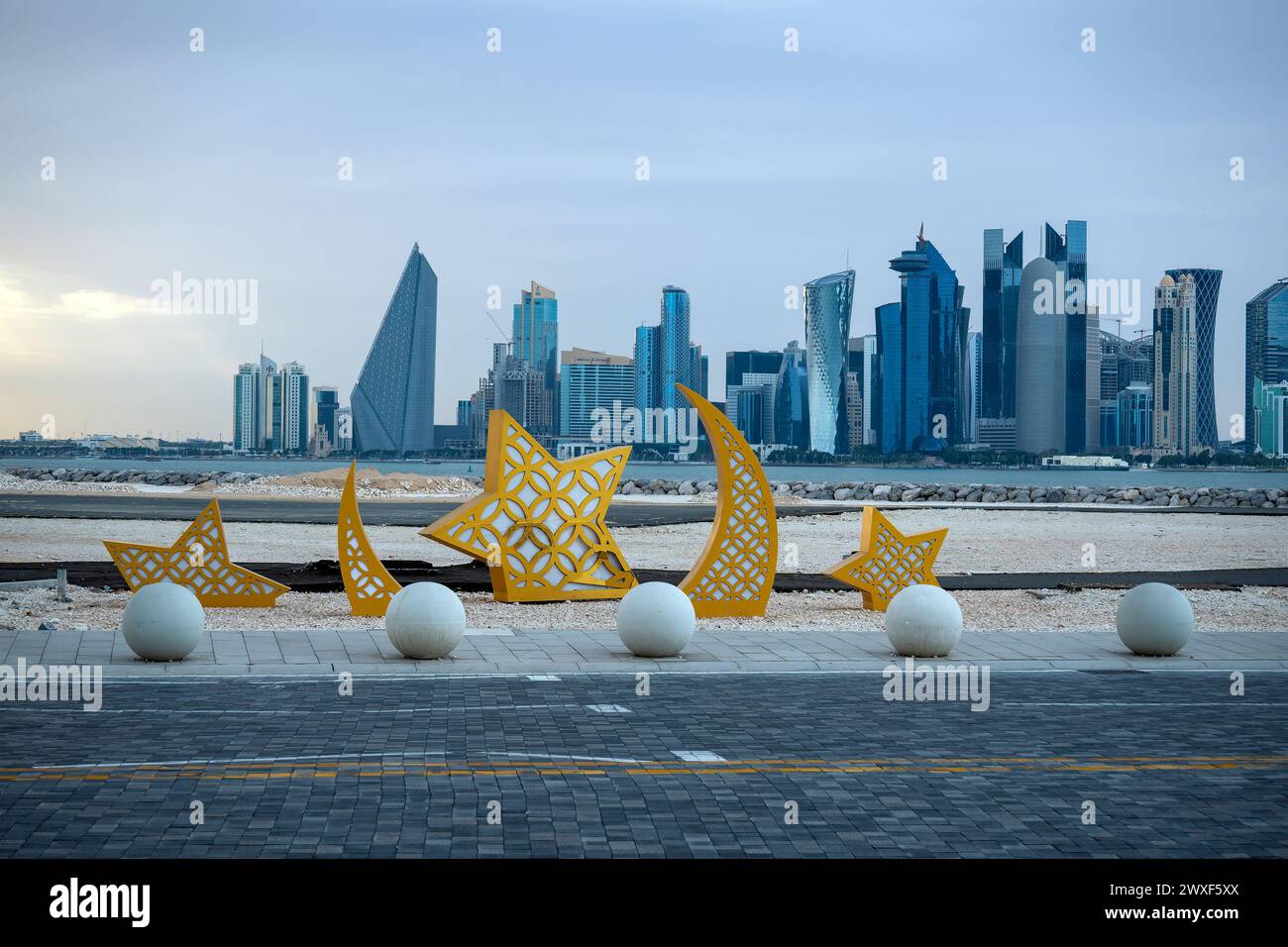 A crescent moon-shaped decorations with lights during the Muslim holy fasting month of Ramadan at Mina District at the Old Doha Port in Doha, Qatar. Stock Photo