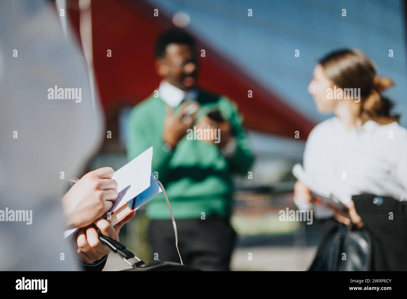 Multicultural business team discussing strategy outdoors Stock Photo