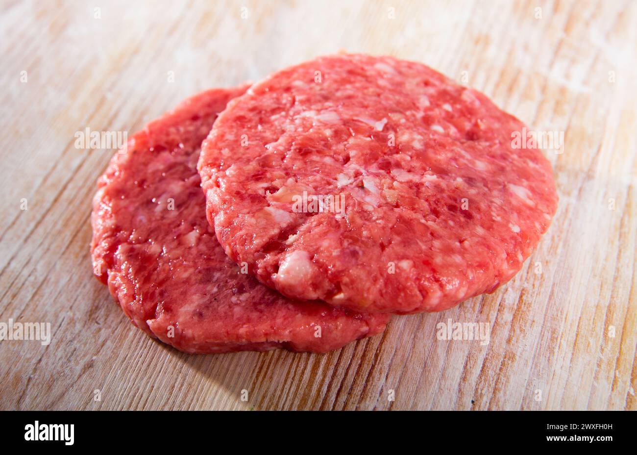 Top view of raw cutlet on wooden table. High quality photo Stock Photo