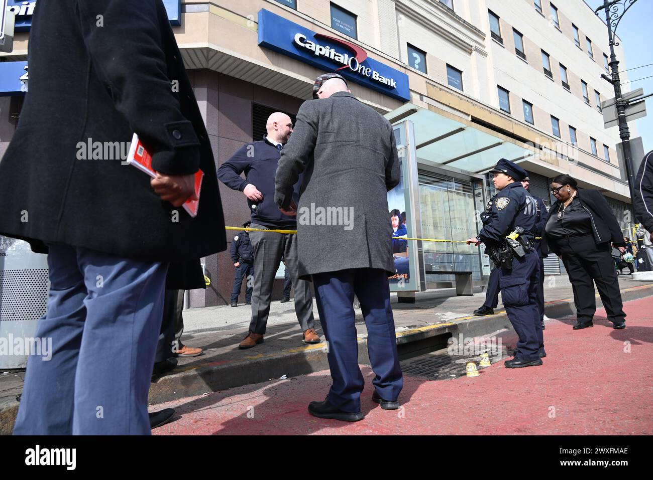 Police officers mark where shell casings were found at the scene of a ...