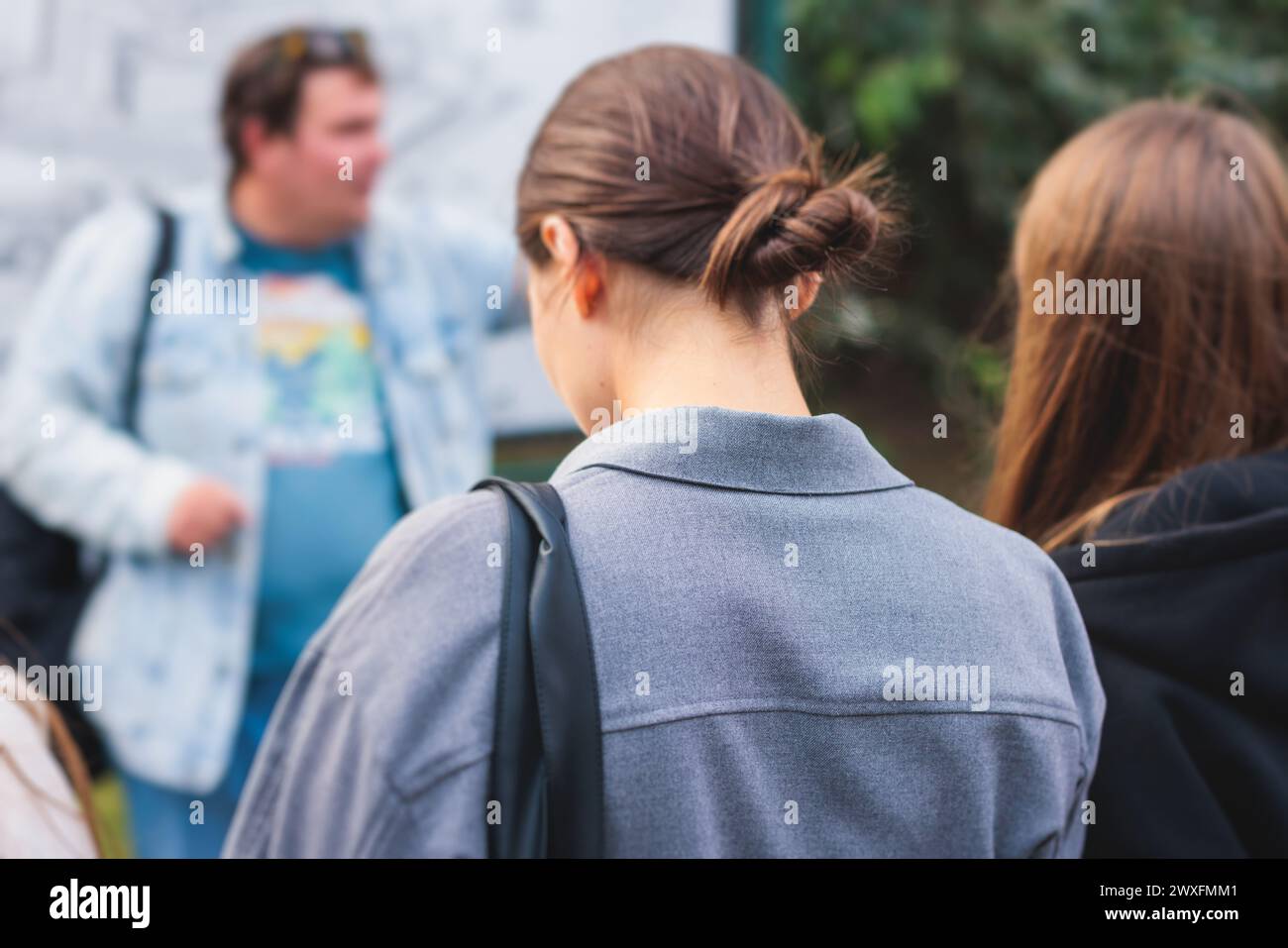 Group of students and school pupils on outdoor excursion tour in the