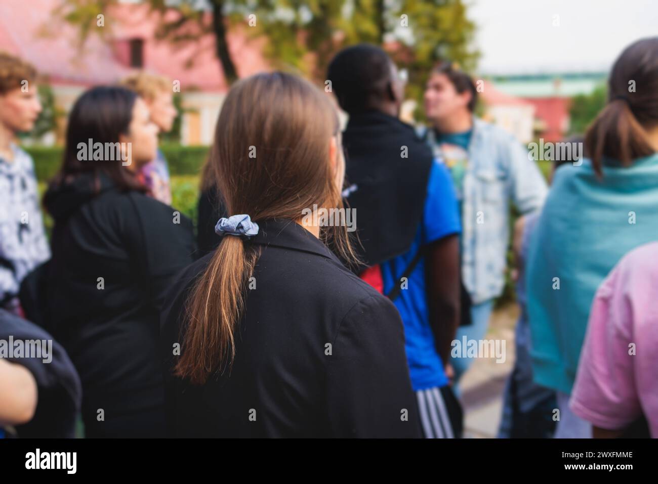 Group of students and school pupils on outdoor excursion tour in the