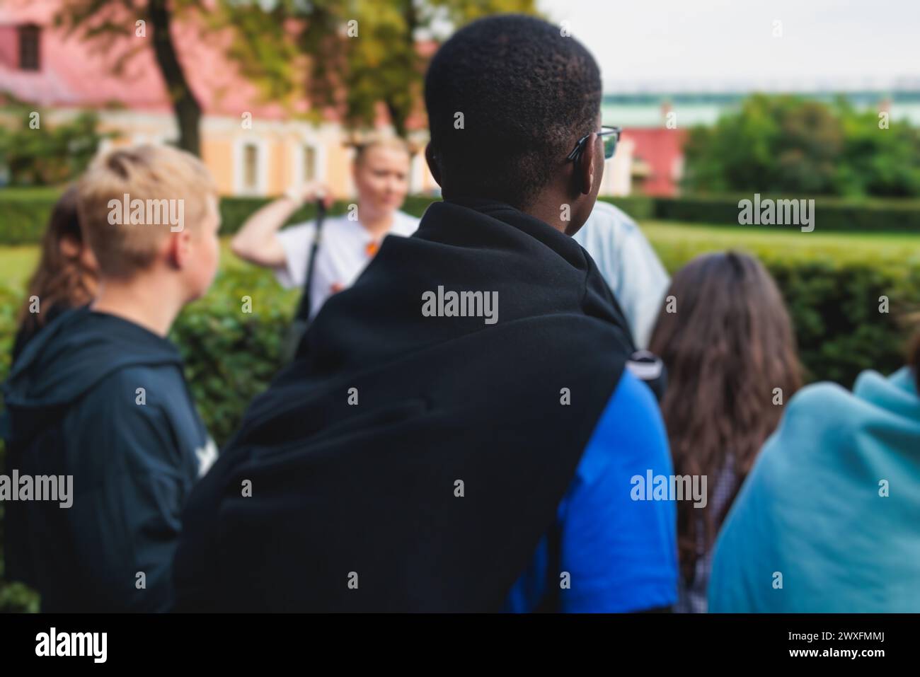 Group of students and school pupils on outdoor excursion tour in the