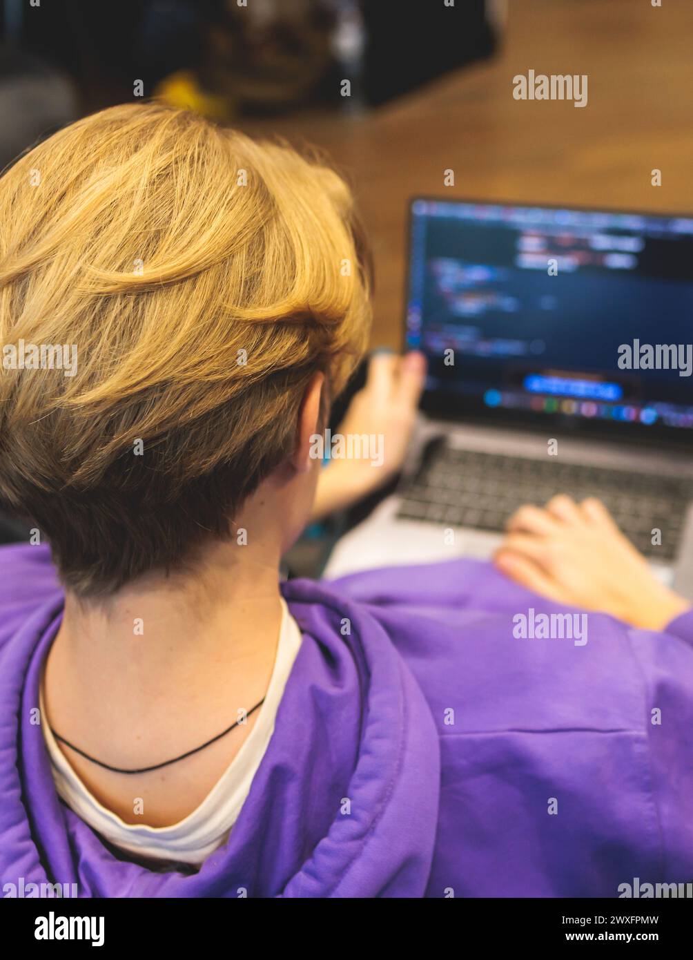 Software developer students in auditorium hall working on computer and ...