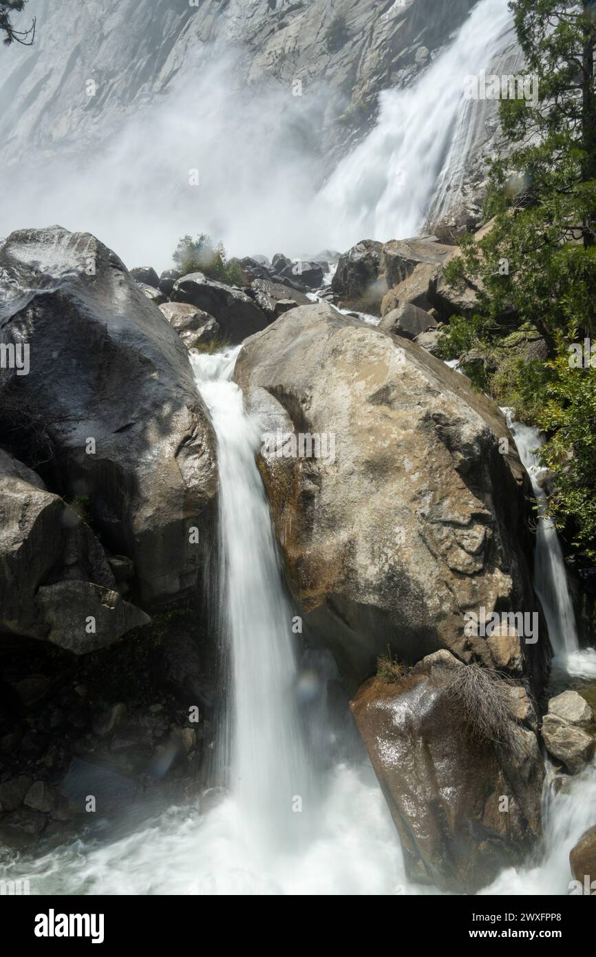 Streams of Water Rush Over Rocks from Wapama Falls in Yosemite Stock Photo