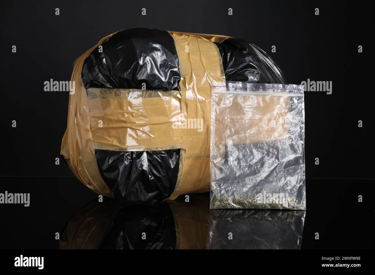 Smuggling and drug trafficking. Packages with narcotics on black mirror surface Stock Photo