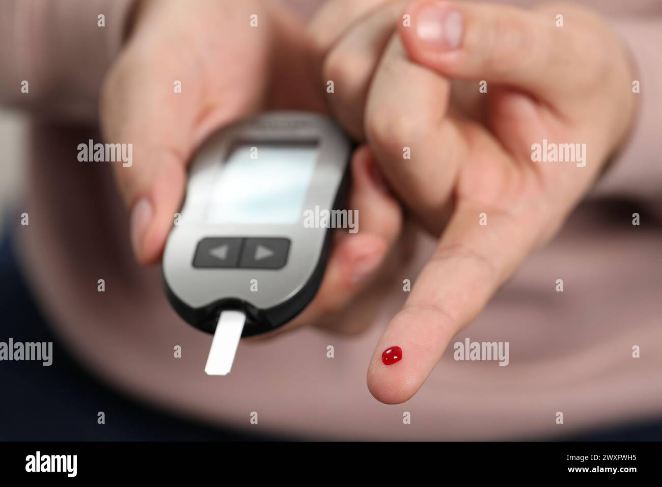 Man Using Glucometer Diabetes test. Man checking blood sugar level with glucometer, closeup ...