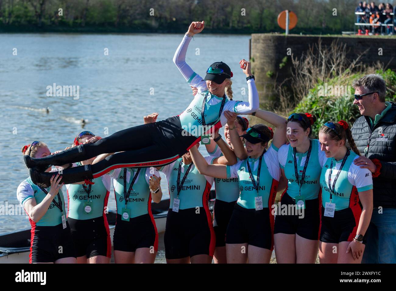 London, Britain. 30th Mar, 2024. Crew members of Cambridge lift their cox Hannah Murphy (top) after winning the women's boat race between Oxford University and Cambridge University in London, Britain, March 30, 2024. Credit: Stephen Chung/Xinhua/Alamy Live News Stock Photo