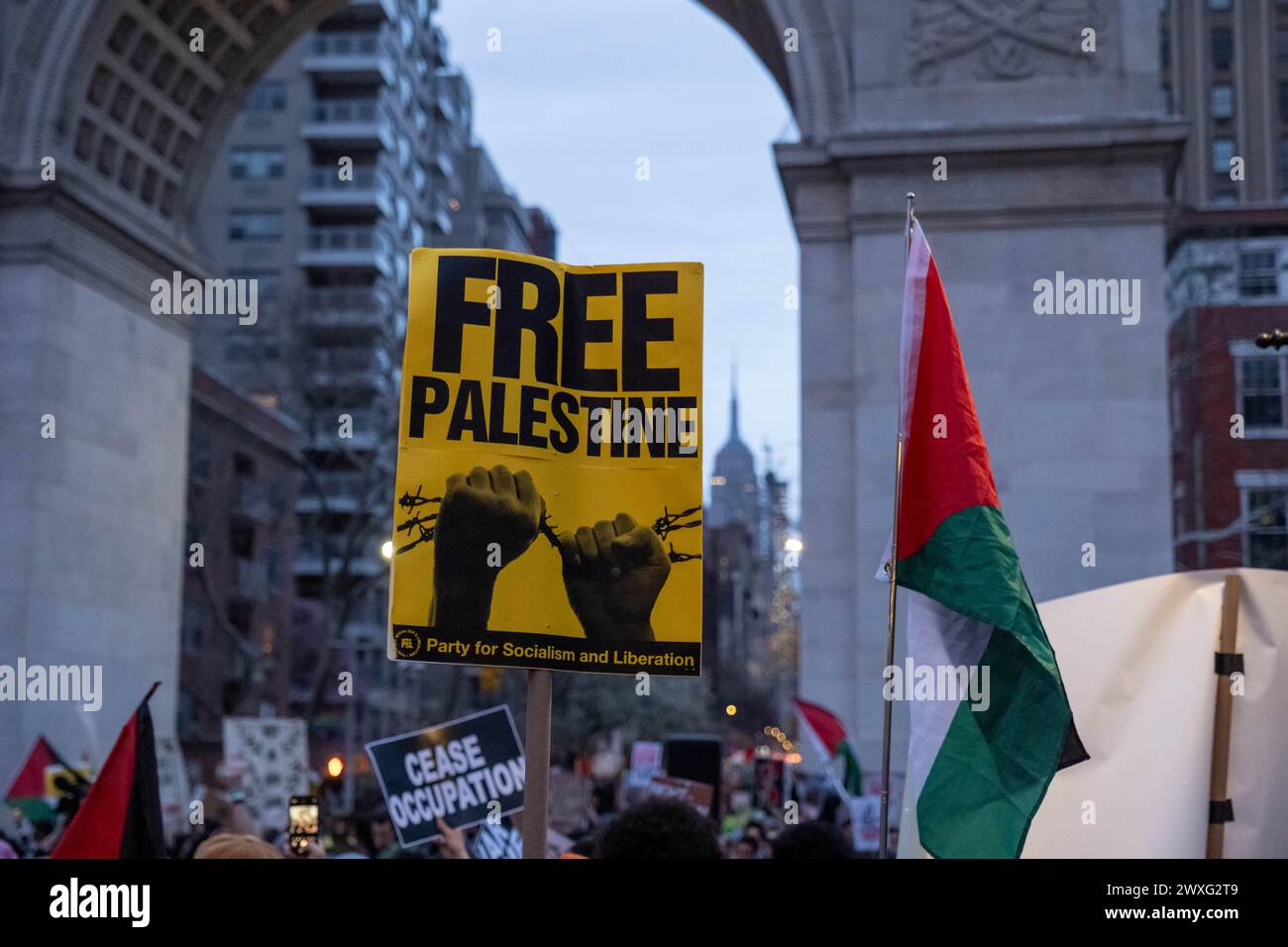 New York, United States. 30th Mar, 2024. Close up of a Free Palestine sign in front of the Arch at Washington Square Park. Pro-Palestine protesters gather in Times Square and then march to Washington Square Park for Land Day. The day commemorates the killing of 6 Palestinians, protesting the confiscation of Palestinian land, by Israeli troops in 1976. Credit: SOPA Images Limited/Alamy Live News Stock Photo