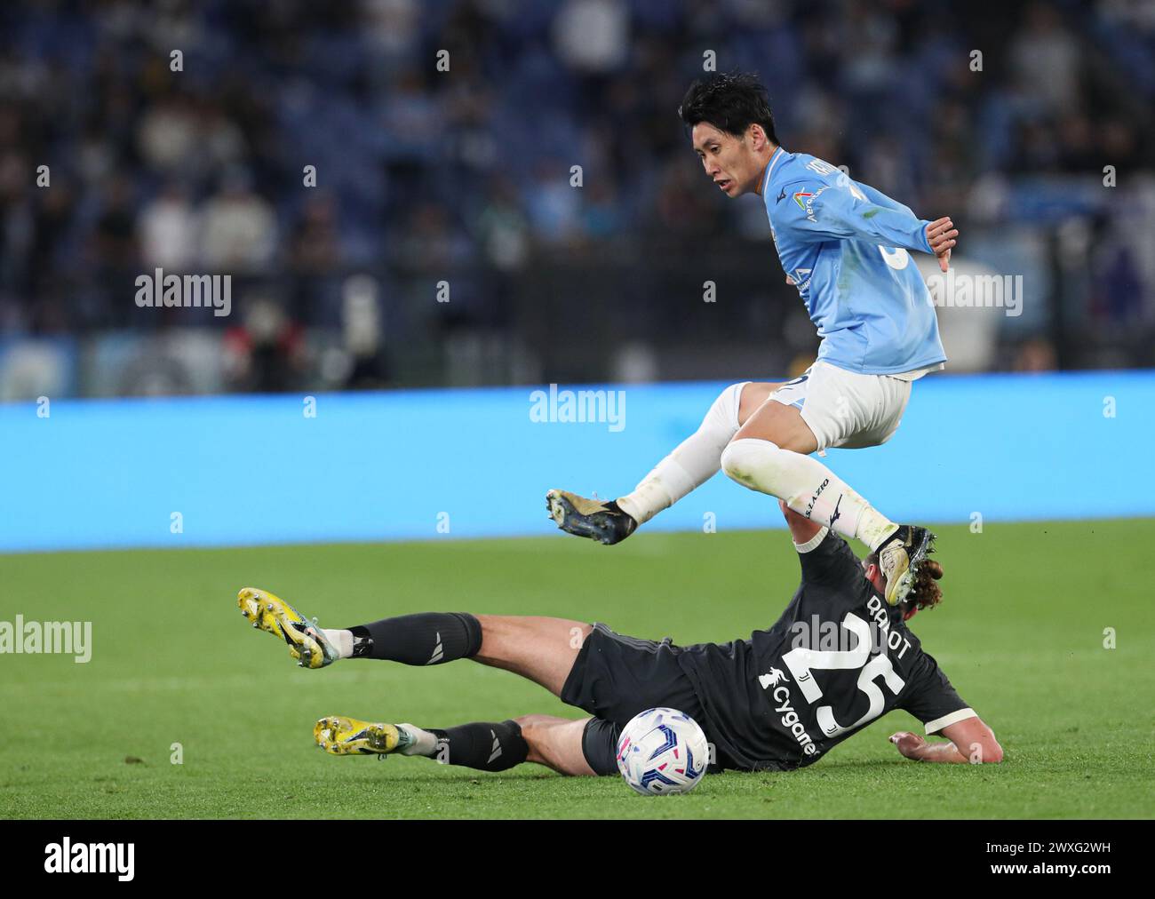 Rome, Italy. 30th Mar, 2024. Lazio's Kamada Daichi (top) vies with Juventus' Adrien Rabiot during a Serie A football match in Rome, Italy, March 30, 2024. Credit: Li Jing/Xinhua/Alamy Live News Stock Photo