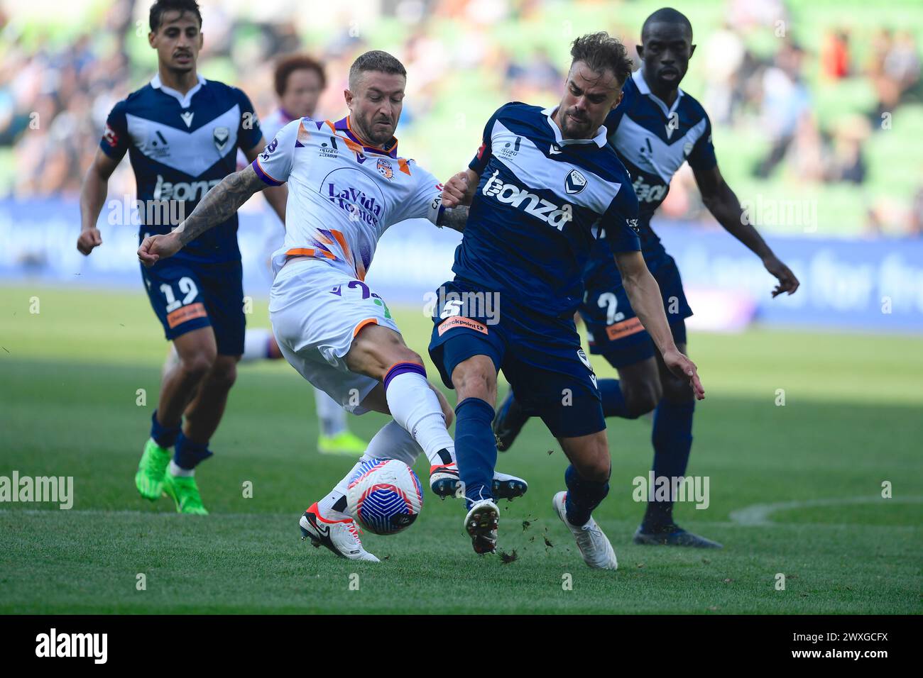 MELBOURNE, AUSTRALIA  31 Mar 2024. Perth Glory Forward Adam Taggart(22) is tackled by Frenchman Damien Da Silva(5) of Melbourne Victory during the A League Men Round 22 Melbourne Victory v Perth Glory at AAMI Park, Melbourne, Australia. Credit: Karl Phillipson/Alamy Live News Stock Photo