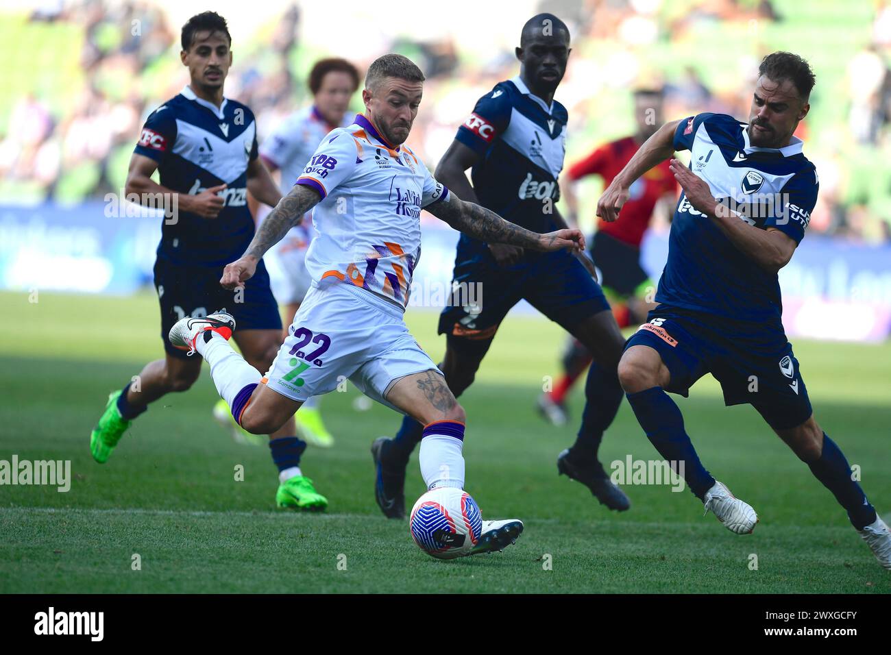 MELBOURNE, AUSTRALIA  31 Mar 2024. Perth Glory Forward Adam Taggart(22) takes a shot on goal as Frenchman Damien Da Silva(5) of Melbourne Victory intervenes during the A League Men Round 22 Melbourne Victory v Perth Glory at AAMI Park, Melbourne, Australia. Credit: Karl Phillipson/Alamy Live News Stock Photo