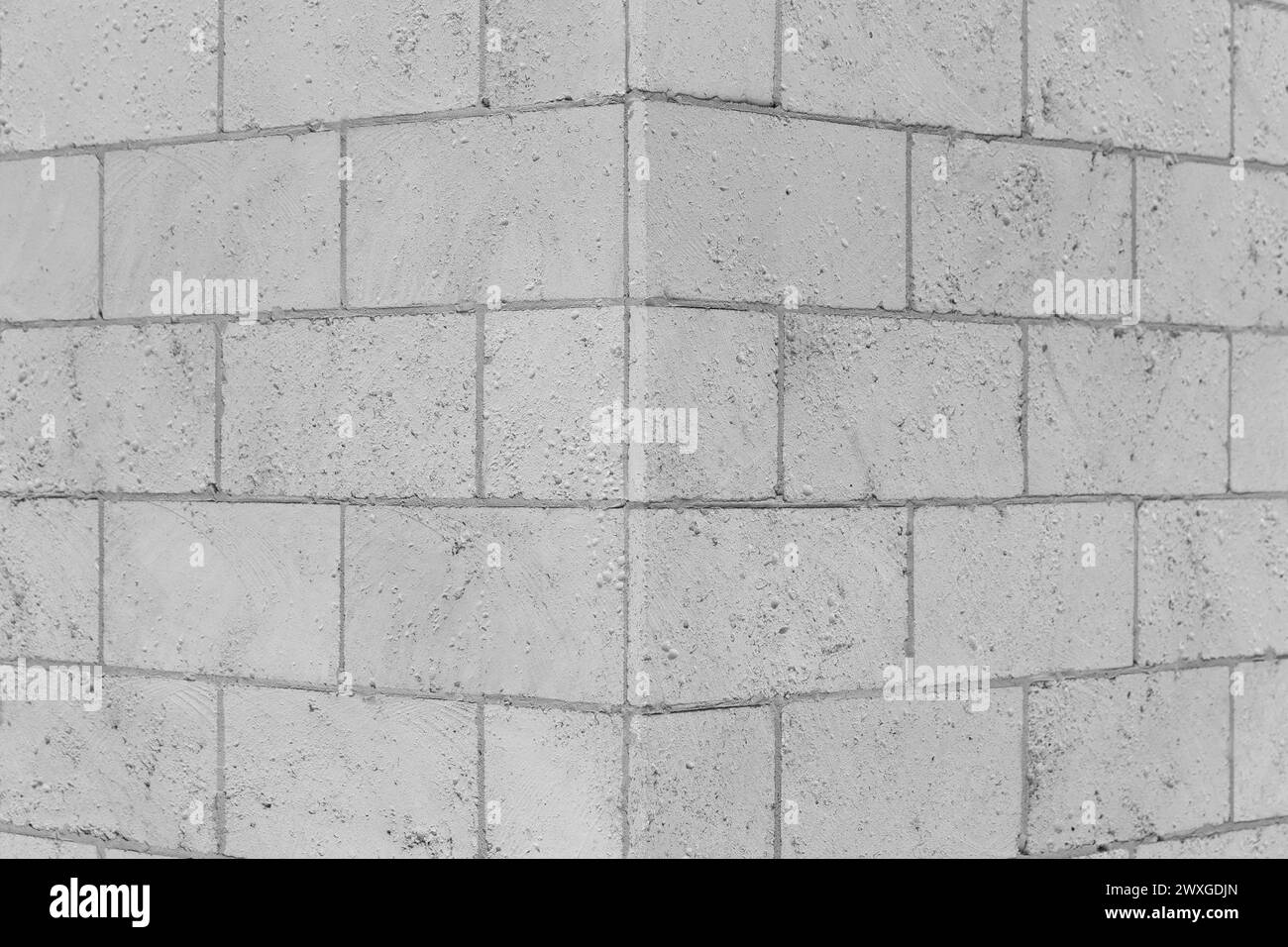 Brickwork brick masonry wall corner joint background architecture facade exterior building sand gray limestone shellbrick. Stock Photo