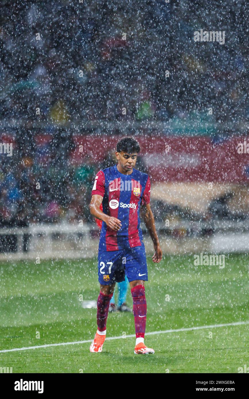 Barcelona, Spain. 30th Mar, 2024. Lamine Yamal in action under the rain during the LaLiga EA Sports match between FC Barcelona and UD Las Palmas at the Estadi Olimpic Lluis Companys in Barcelona, Spain. Credit: Christian Bertrand/Alamy Live News Stock Photo
