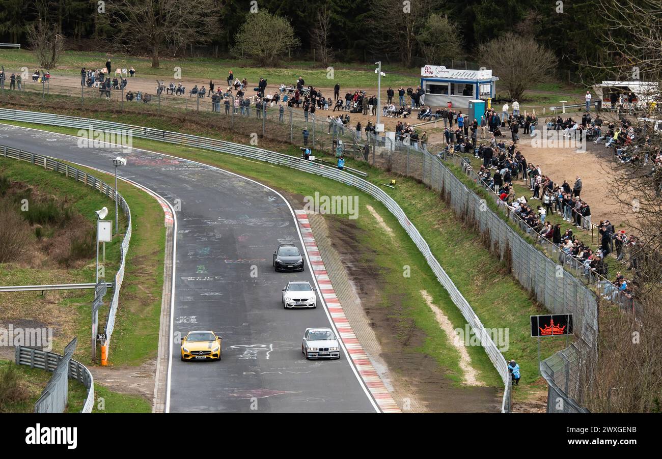 SYMBOL - 30 March 2024, Rhineland-Palatinate, Nürburg: Numerous car fans line the Nordschleife of the Nürburgring during the tourist drives. Photo: Silas Stein/dpa Stock Photo