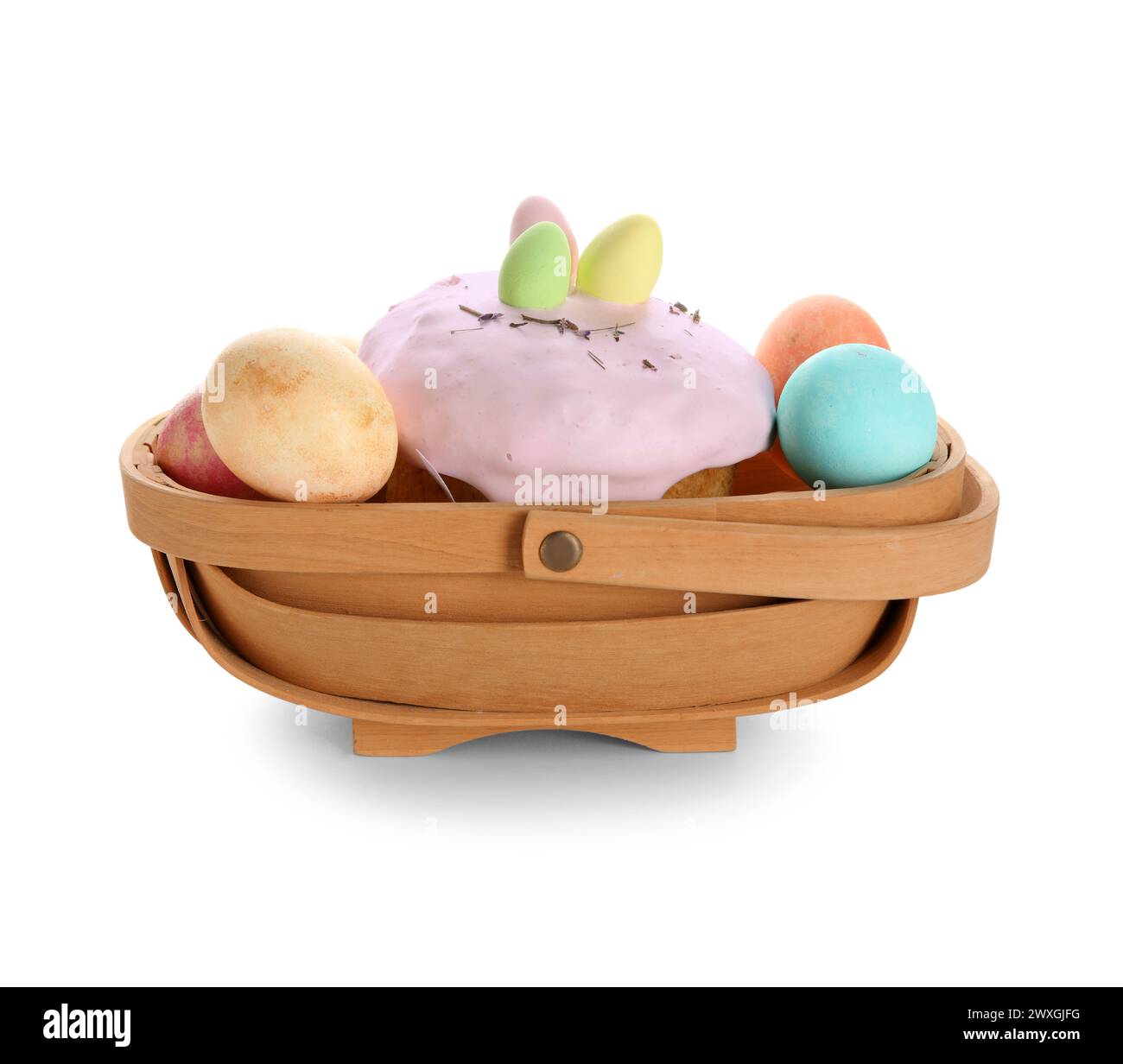 Basket with Easter cake and painted eggs isolated on white background Stock Photo