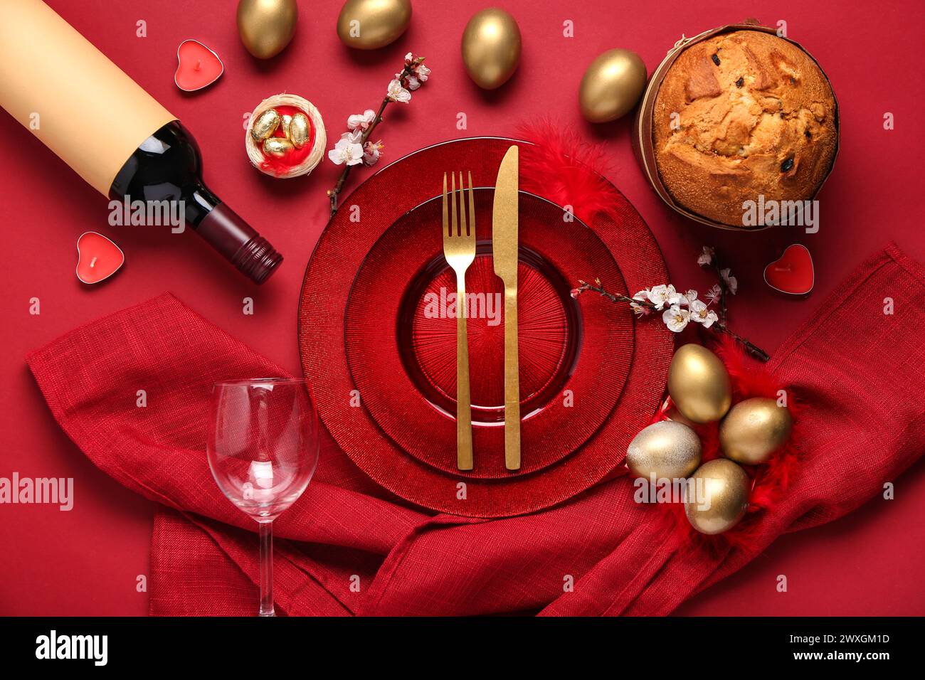 Beautiful table setting with Easter eggs on red background Stock Photo