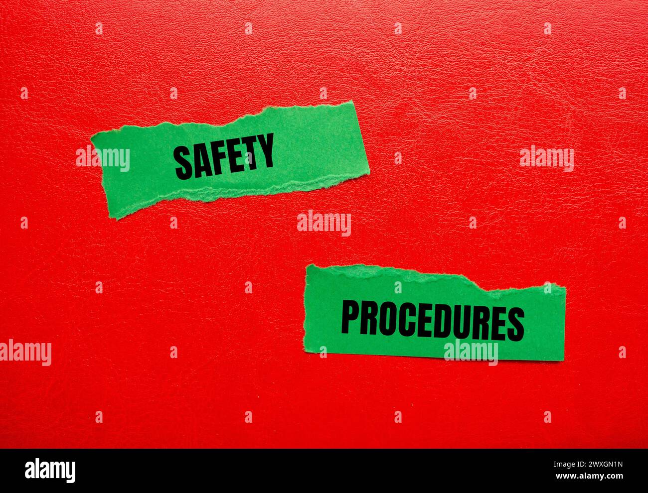 Safety procedures words written on green torn paper pieces with red background. Conceptual symbol. Copy space. Stock Photo
