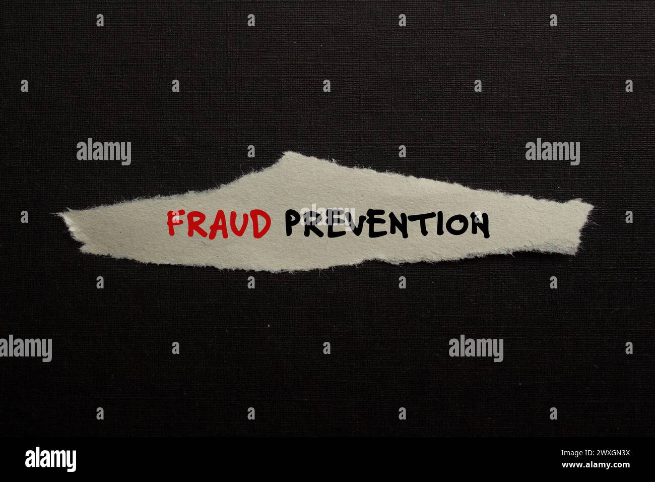 Fraud prevention words written on torn paper piece with black background. Conceptual symbol. Copy space. Stock Photo