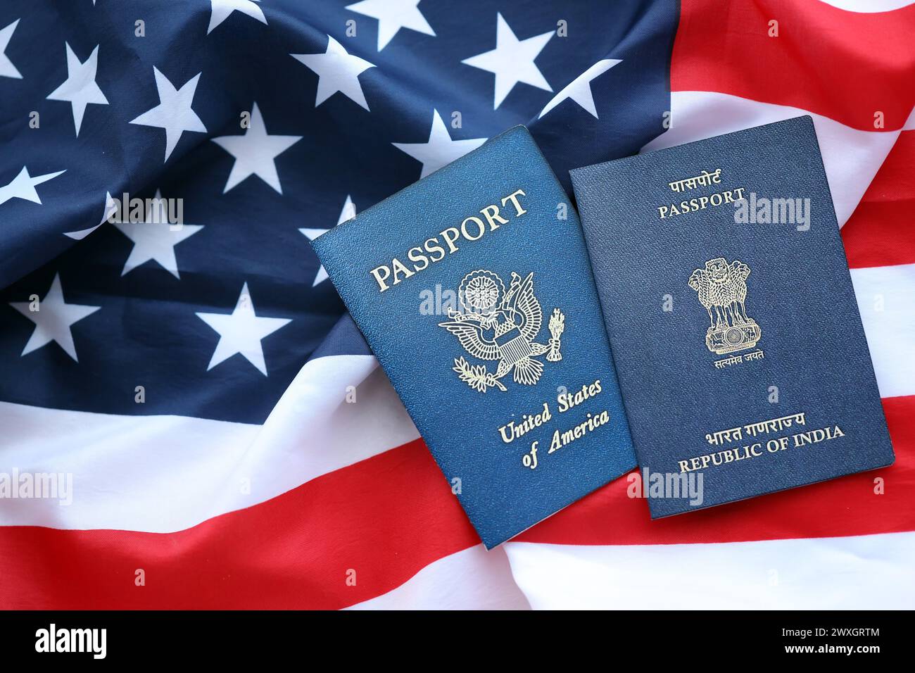 Passport of India with US Passport on United States of America folded flag close up Stock Photo