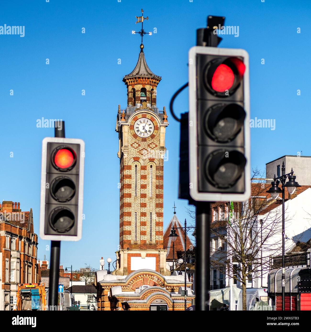 Epsom Surrey, UK, March 30 2024, Red Traffic Stop Lights With Clock Tower In Background And No People Stock Photo