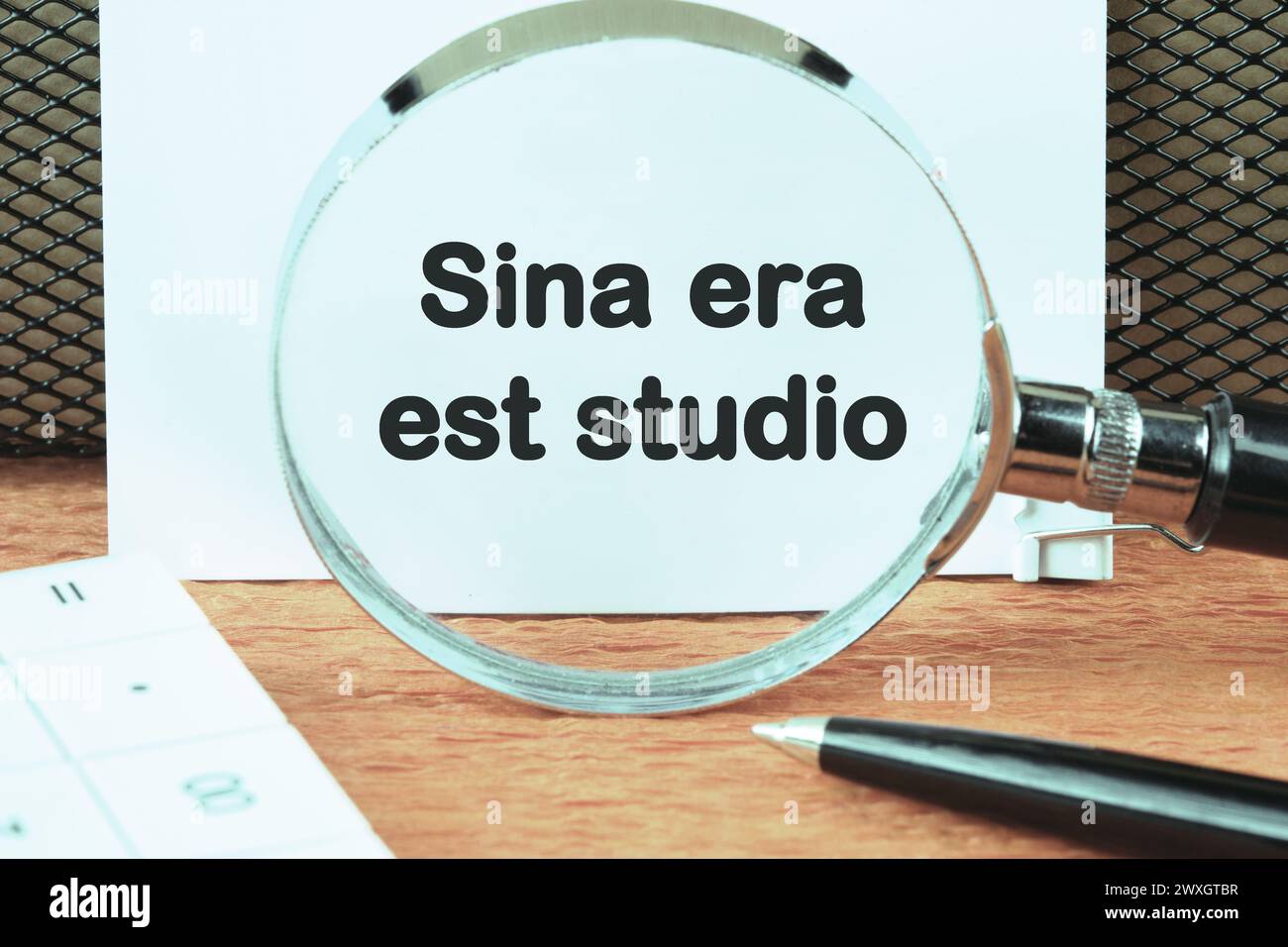Sina era est studio It means Without anger and addiction an inscription was found using a magnifying glass on a white sheet. Concept photo Stock Photo