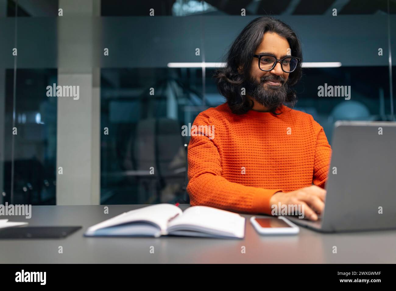 Man working on laptop in modern office Stock Photo