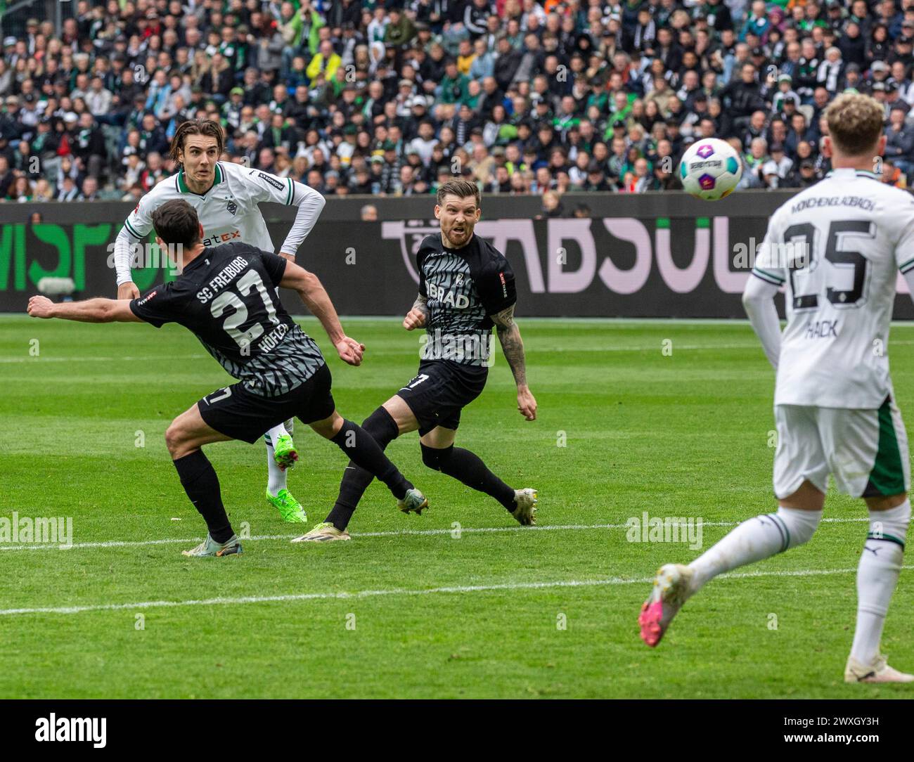 sports, football, Bundesliga, 2023/2024, Borussia Moenchengladbach vs. SC Freiburg 0-3, Stadium Borussia Park, scene of the match, f.l.t.r. Nicolas Hoefler (SCF), Florian Neuhaus (MG) shots on goal, Lukas Kuebler (SCF), Robin Hack (MG), DFL REGULATIONS PROHIBIT ANY USE OF PHOTOGRAPHS AS IMAGE SEQUENCES AND/OR QUASI-VIDEO Stock Photo