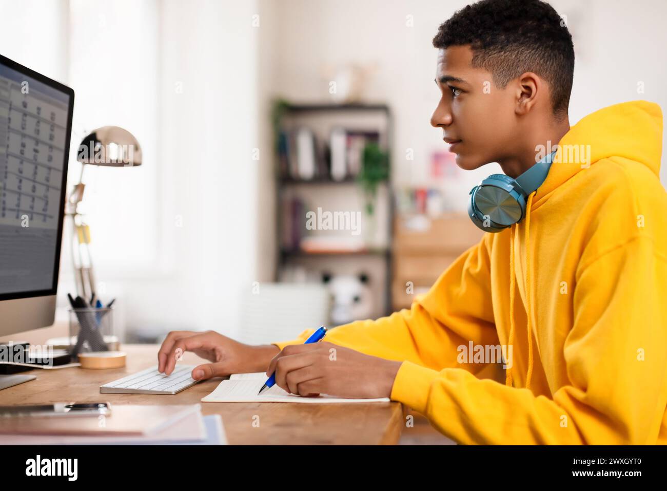 Young person working on desktop computer Stock Photo