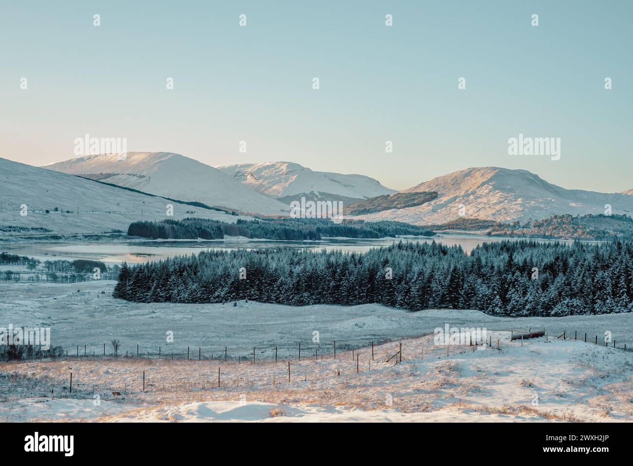 Loch Tulla and snow-covered mountains in the Scottish highlands, from a viewpoint on the A82 Stock Photo