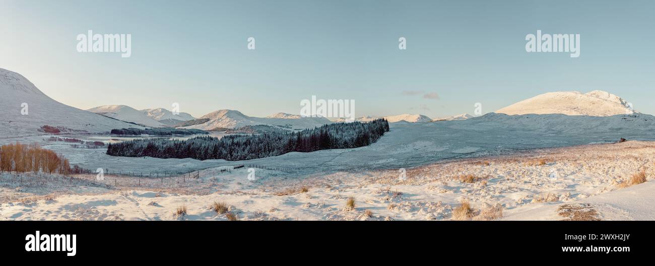 A panoramic view of Loch Tulla (right) and the Black Mount (left) on a sunny day in the Scottish Highlands. Taken from a viewpoint on the A82 Stock Photo