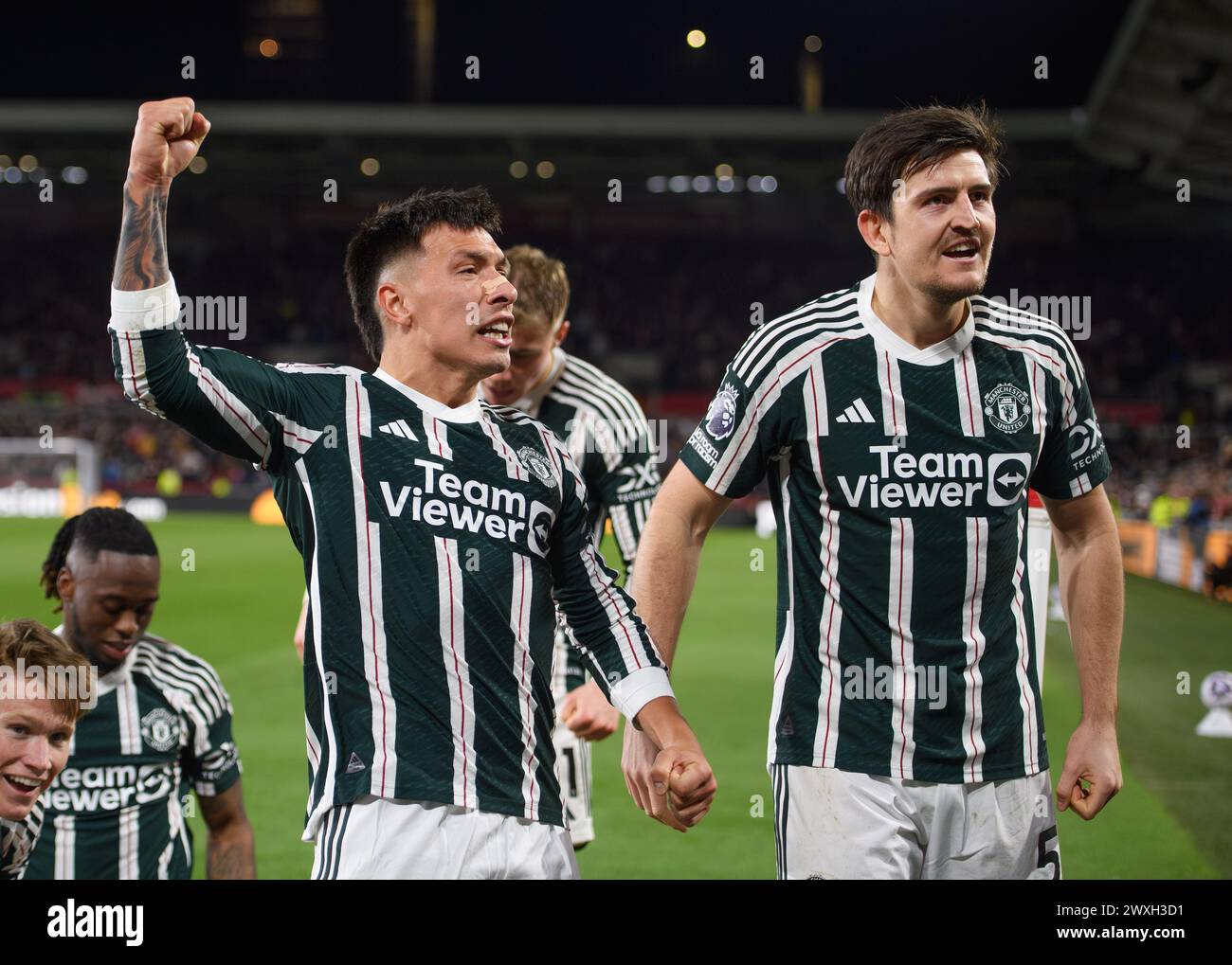 London, UK. 30th Mar, 2024 - Brentford v Manchester United - Premier League - GTech Community Stadium. Lisandro Martinez and Harry Maguire celebrate Manchester United's late goal. Picture Credit: Mark Pain/Alamy Live News Stock Photo