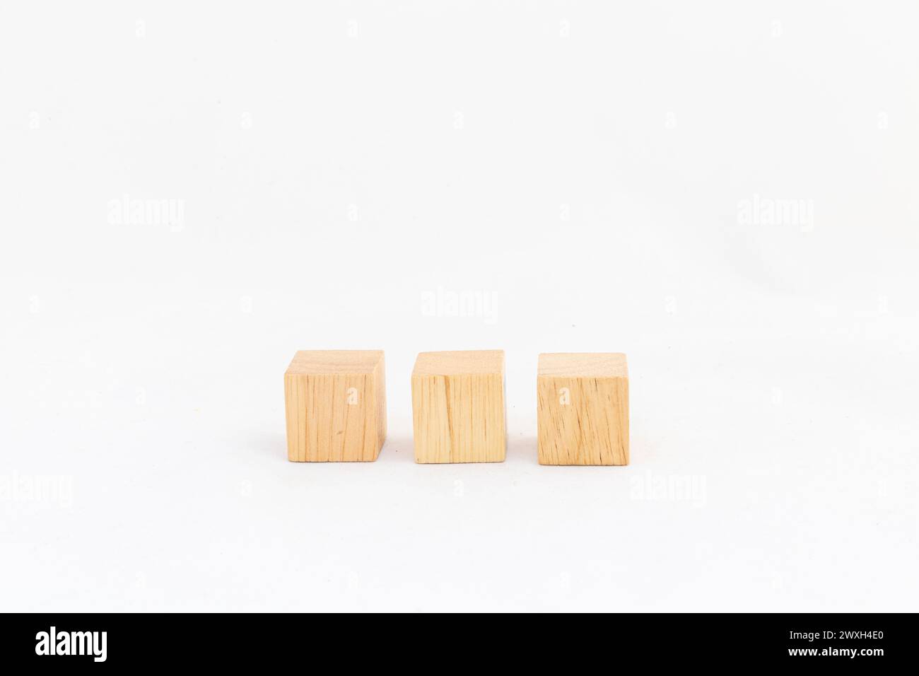 Three wooden cubes isolated on a white background Stock Photo - Alamy