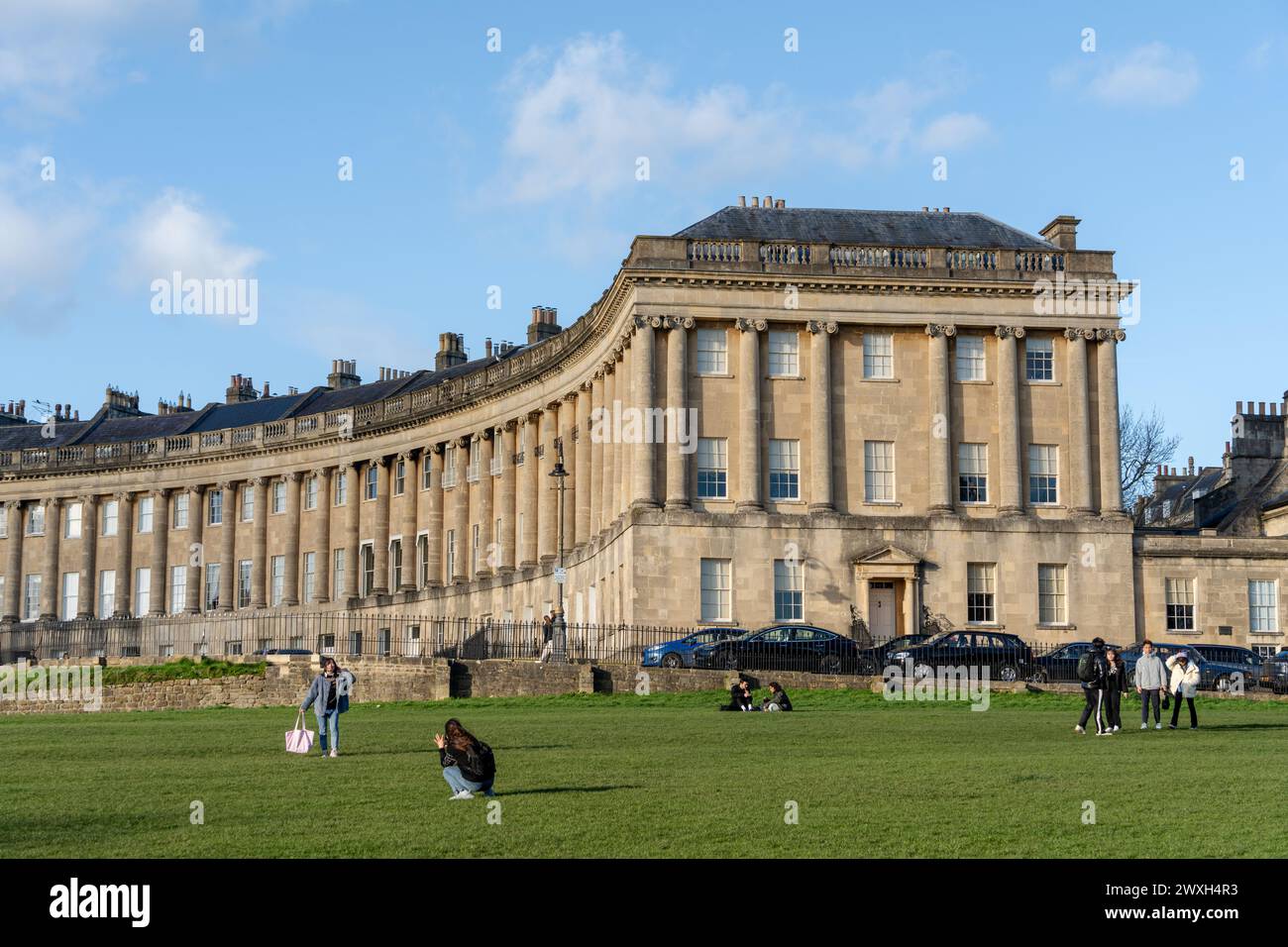 The Royal Crescent - Grade I Listed terrace houses in the city of Bath, Somerset, UK, a popular destination for tourists. Stock Photo
