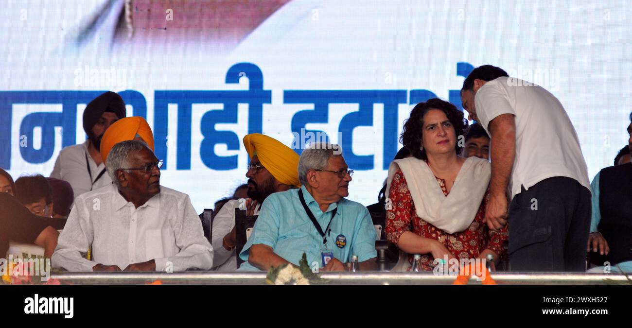 March 31, 2024, New Delhi, Delhi, INDIA: Rahul Gandhi chating with his sister Priayanka Gandhi alos looks on cpi and cpm leaders during All forty opposition political Parties Leaders of INDIA (Indian National Development Inclusive Alliance) at the public meeting for (SAVE DEMOCRACY) 'loktantr bachao' against BJP Rulling Party who Rise on the oppostion parties leaders the corruption charges, Raids of CBI, ED & income tax on all seniors opposition leaders, Ministers and others Leaders were put in jail as soon as general elections were declared in the country, Rally at Ramlila maidan in New Delhi Stock Photo