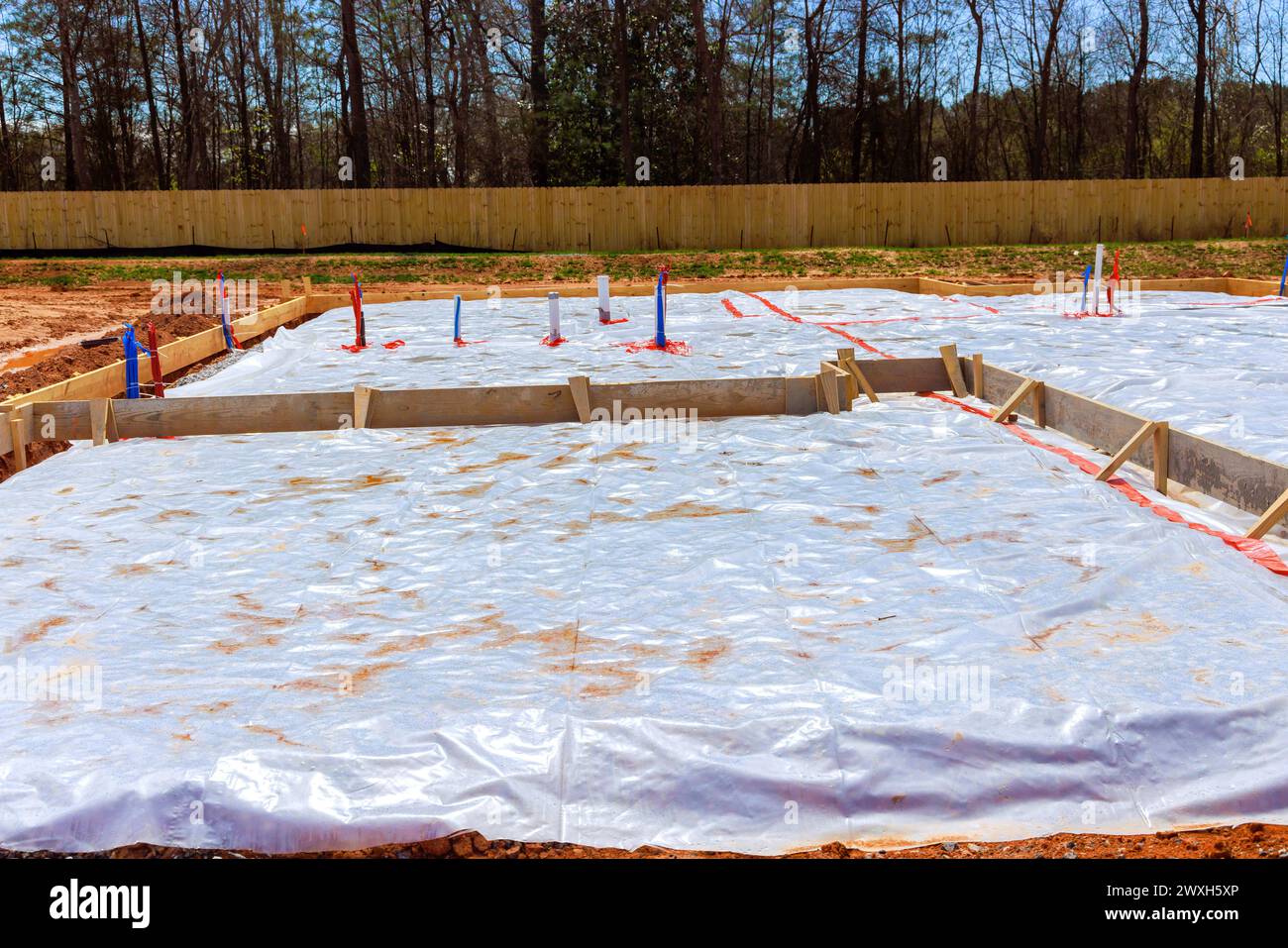 During construction of house, ground is covered with waterproofing layer before foundation is poured Stock Photo