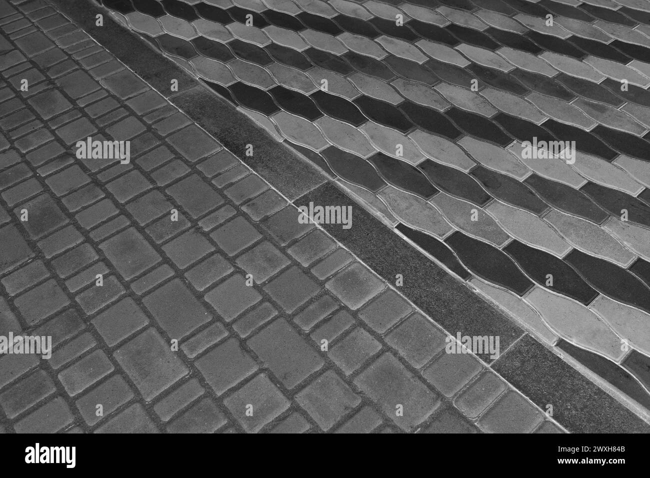 Two Kinds Paving Black Tiles Dividing Border Curb Mosaic Stone Street Road City Texture Background Dark Line. Stock Photo