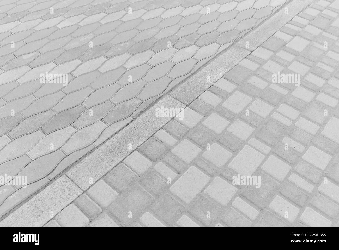 Two Kinds Paving Tiles Dividing Border Curb Mosaic Stone Street Road City Texture Background Light White. Stock Photo