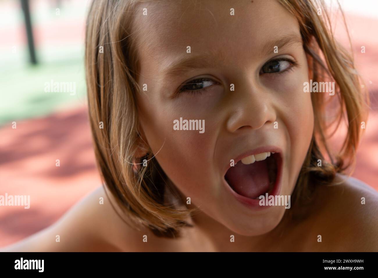 Portrait of blond boy with surprised face seen up close Stock Photo