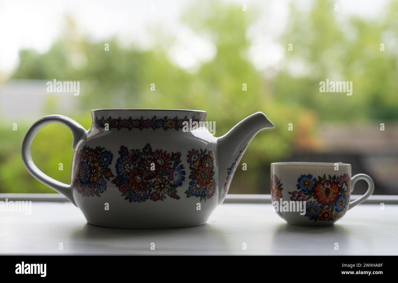 Teapot and cup with tea seen from close up Stock Photo