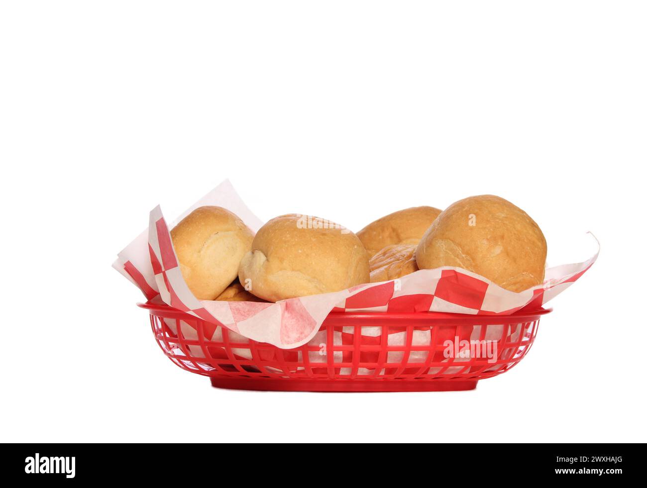 Basket filled with freshly baked buns on a white backdrop Stock Photo