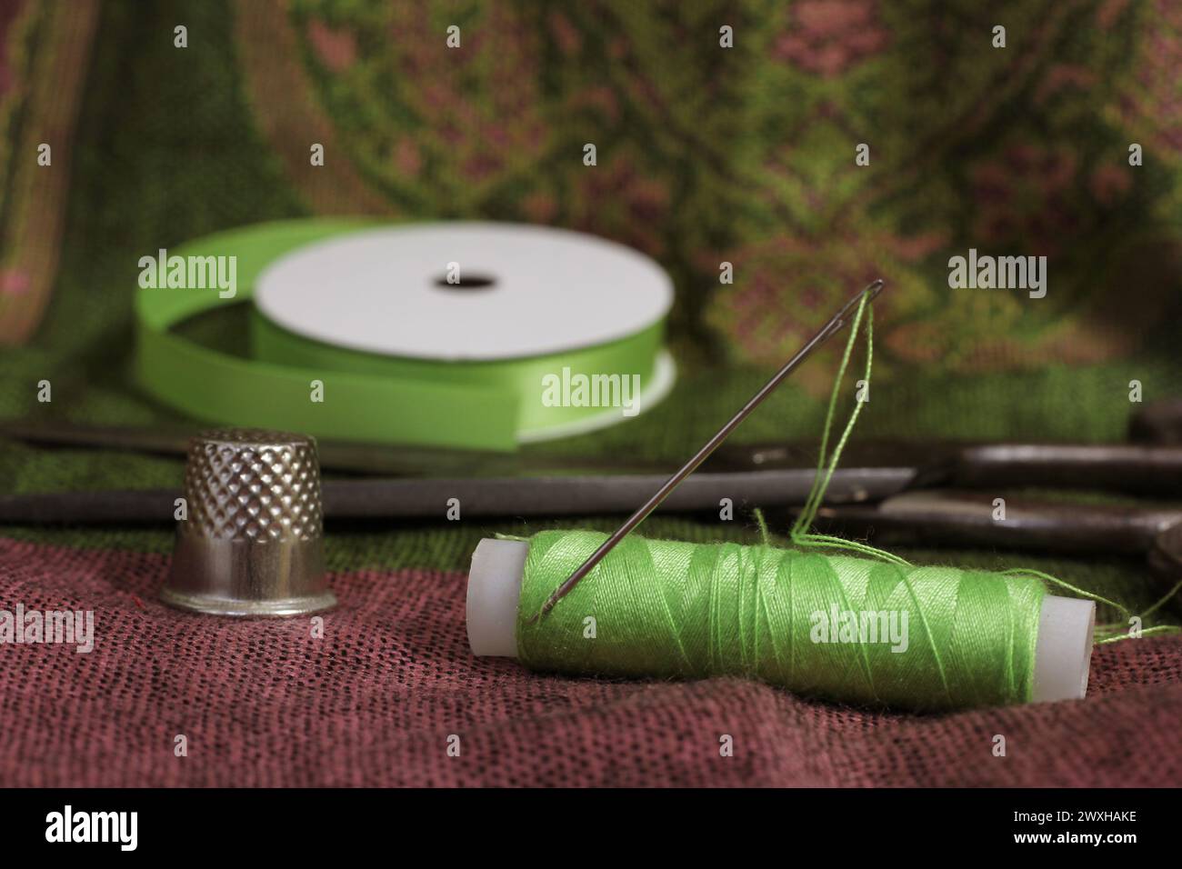 Assorted spools and sewing tools on table Stock Photo