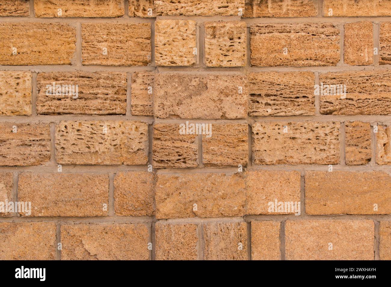 Sand brick blocks shell limestone wall texture background vintage retro color backdrop. Stock Photo