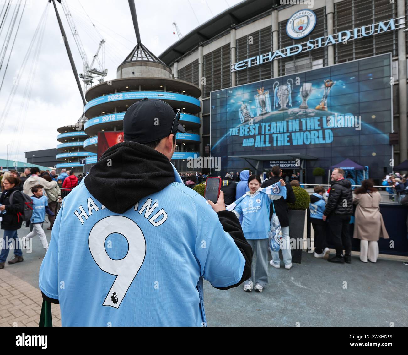 Fans take pictures as they arrive ahead of the the Premier League match Manchester City vs Arsenal at Etihad Stadium, Manchester, United Kingdom, 31st March 2024 (Photo by Mark Cosgrove/News Images) in, on 3/31/2024. (Photo by Mark Cosgrove/News Images/Sipa USA) Credit: Sipa USA/Alamy Live News Stock Photo