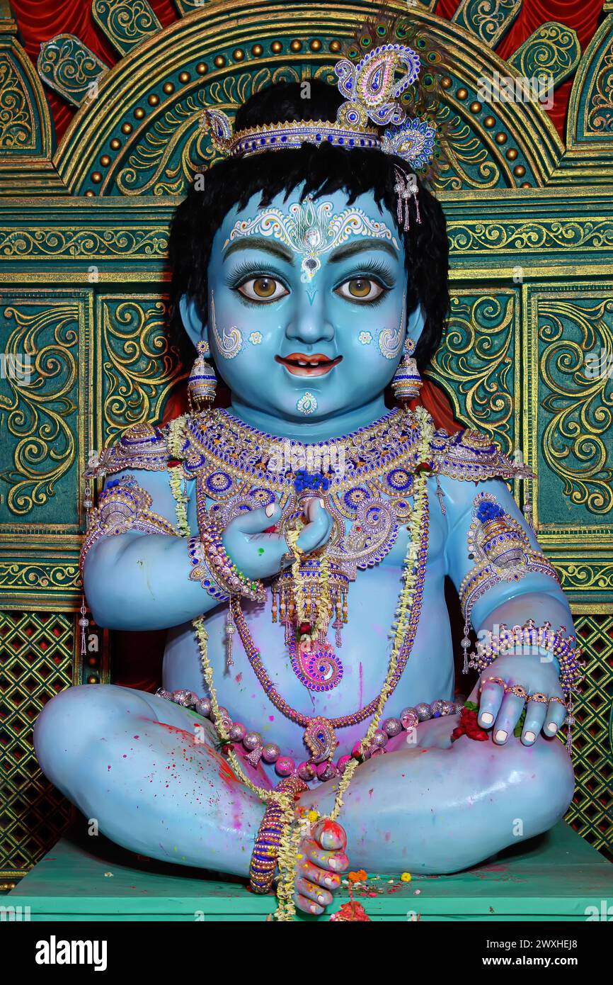 Idol of Goddess Laddu Gopal or little Lord Krishna at a decorated puja pandal in Kolkata, West Bengal, India. Stock Photo