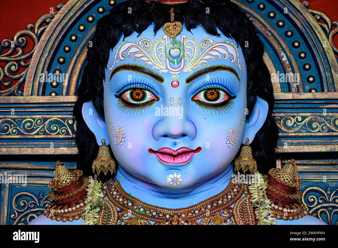Idol of Goddess Laddu Gopal or little Lord Krishna at a decorated puja pandal in Kolkata, West Bengal, India. Stock Photo