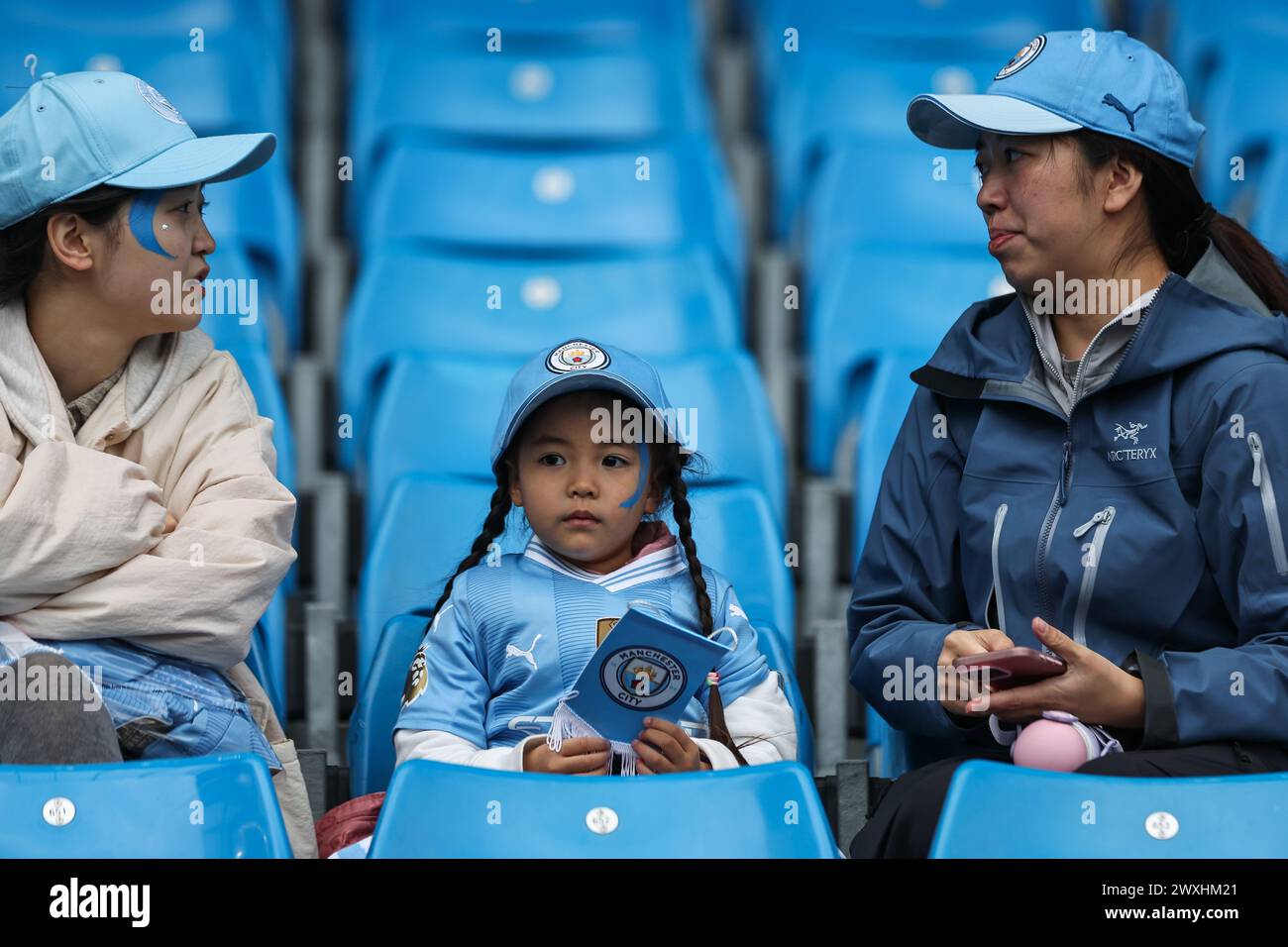 Fans arrive ahead of the Premier League match Manchester City vs Arsenal at Etihad Stadium, Manchester, United Kingdom, 31st March 2024  (Photo by Mark Cosgrove/News Images) Stock Photo