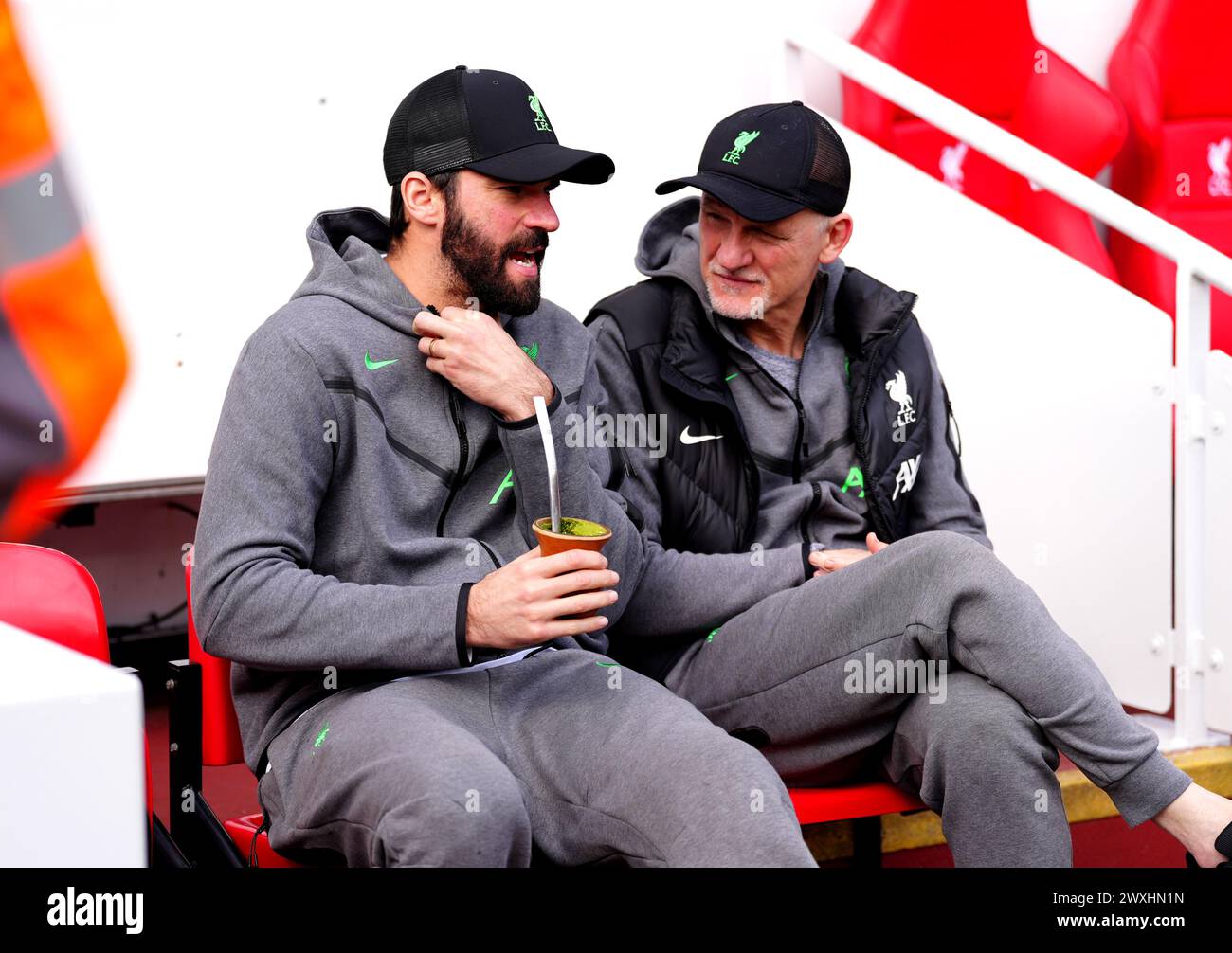Liverpool goalkeeper Alisson Becker (left) speaks to goalkeeping coach Claudio Taffarel ahead of the Premier League match at Anfield, Liverpool. Picture date: Sunday March 31, 2024. Stock Photo