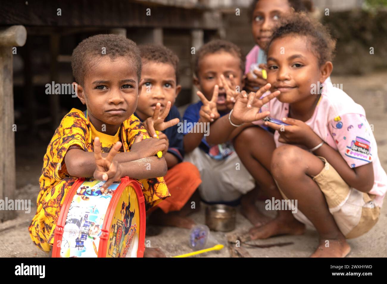 INDONESIA, ISLAND KRI - JANUARY 25, 2024: Little Papuan children pose for a street photographer Stock Photo
