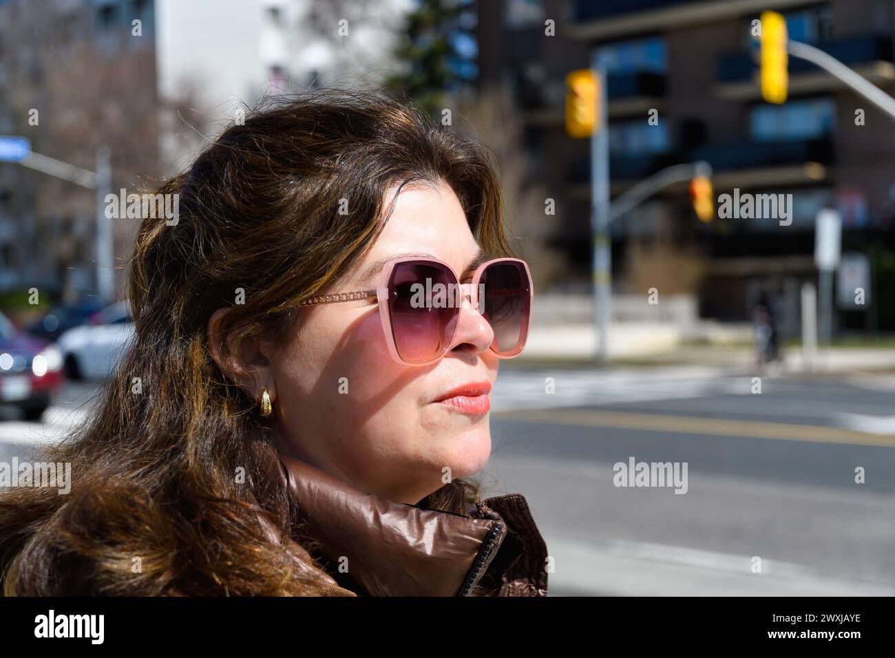 Portrait of a real Latin American woman on a city street, Toronto, Canada Stock Photo